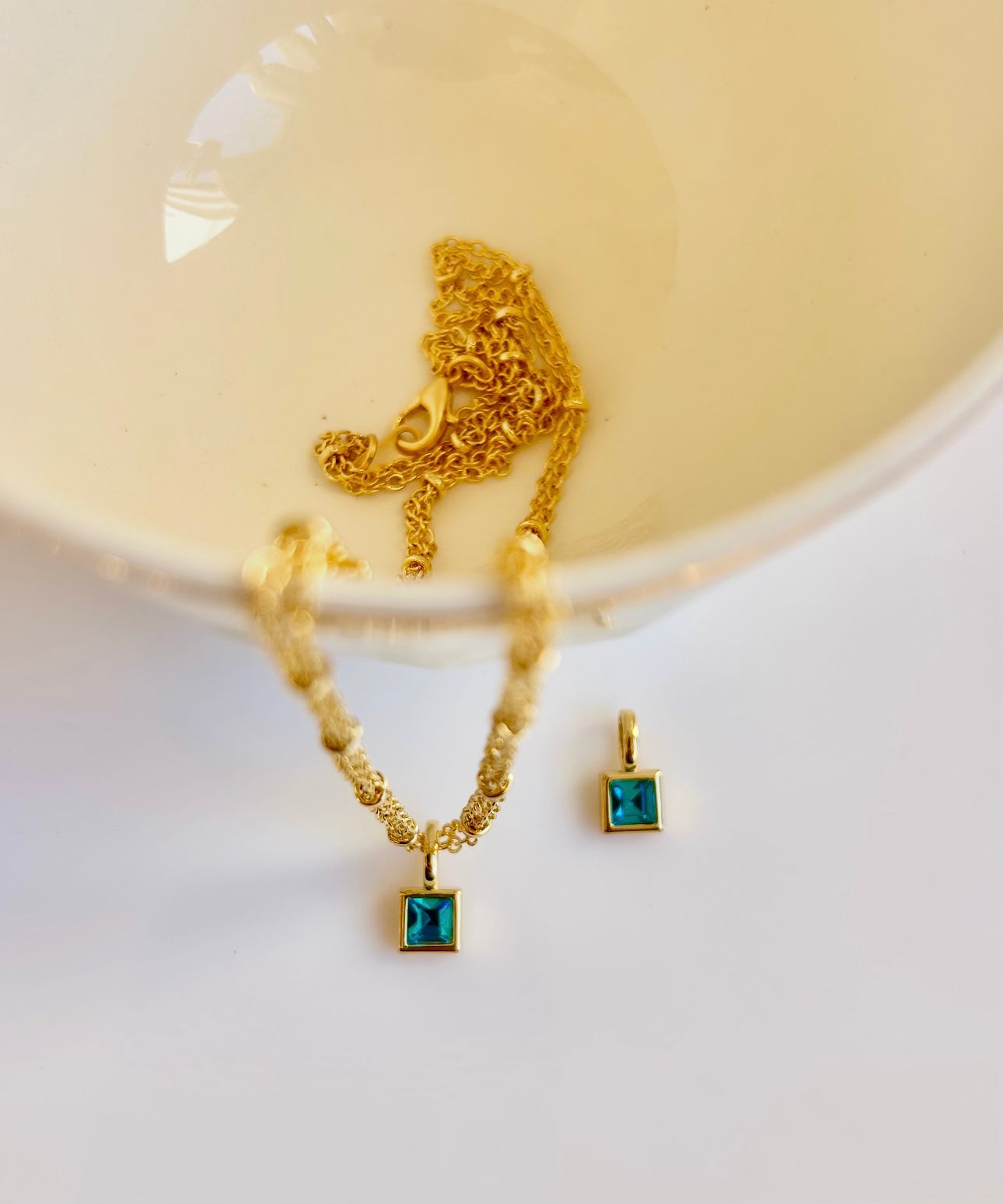 Gold March birthstone pendant necklace with aquamarine light blue gemstone