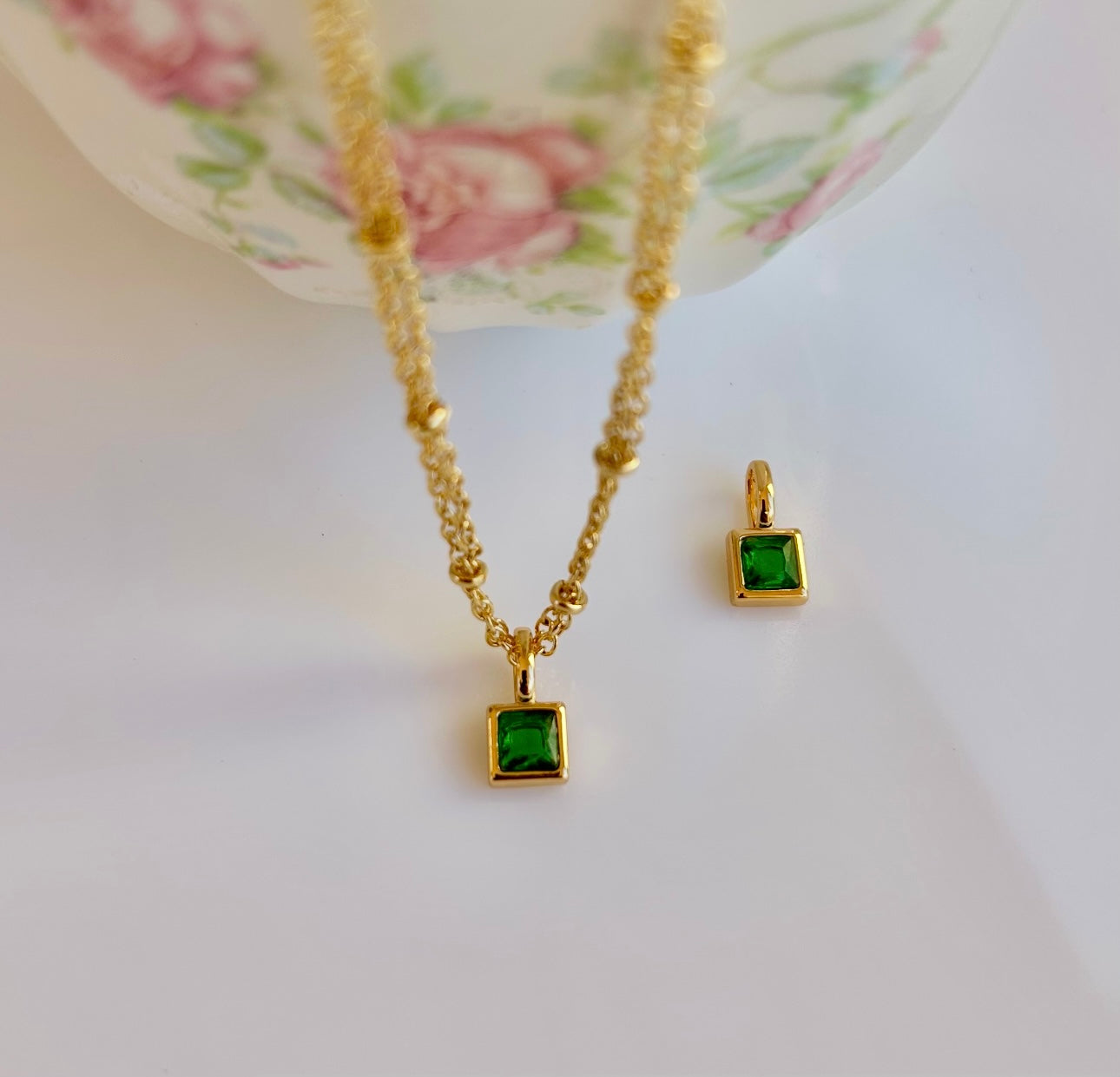 Gold May birthstone pendant necklace with emerald green gemstone