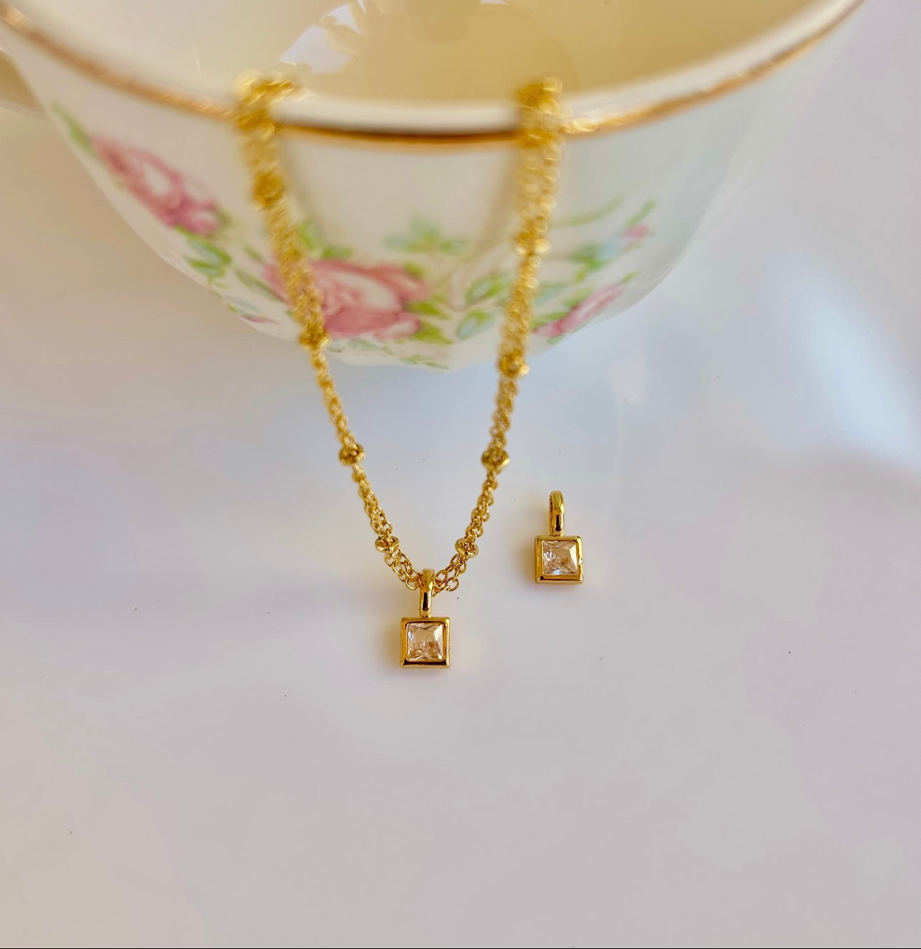 Gold April birthstone pendant necklace with clear diamond-like gemstone
