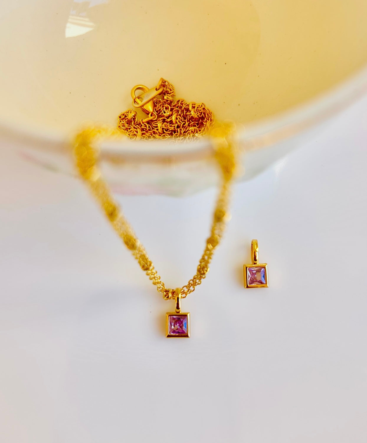 Gold June birthstone pendant necklace with light lavender alexandrite gemstone